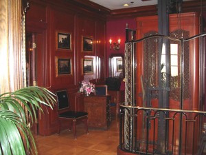 Check-in desk at Club 33, at top of stairs. Elevator on right, door to Trophy Room on left.