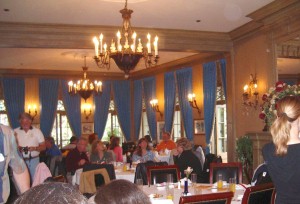 Long view of the main dining room, showing the French doors looking over Royal Street.