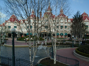 Disneyland Hotel and the park entrance, seen through the entrance plaza trees
